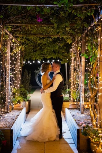  A photo outside under the fairy lights at an osteria weddings reception
