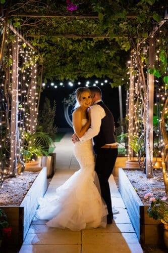 Bride and groom under lights