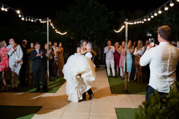 A couple perform their a lift in their first dance