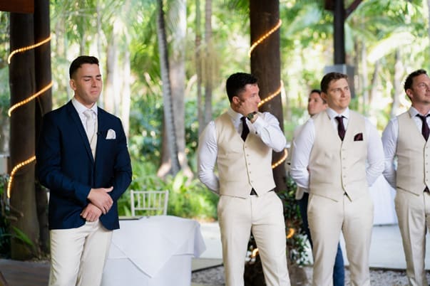 A groom is emotional and cries when he sees his bride walking down the aisle at Cedar Creek Lodges in Tamborine Mountain