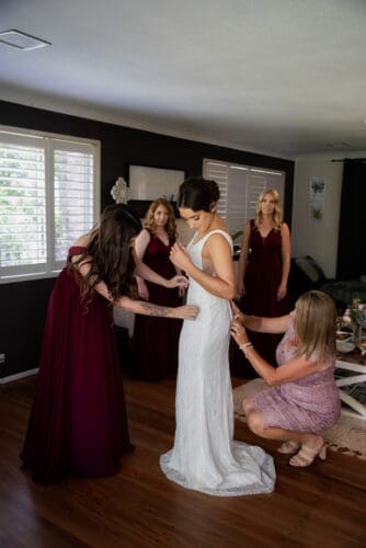 A bride gets dressed at Cedar Creek Lodges 