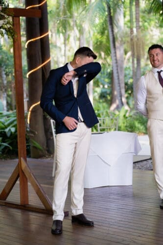 A groom is emotional and cries when he sees his bride walking down the aisle at Cedar Creek Lodges in Tamborine Mountain