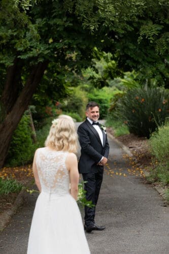 Laura and Rodrigo sharing an intimate first look under the towering fig trees at Mt Coot-tha Botanic Gardens.