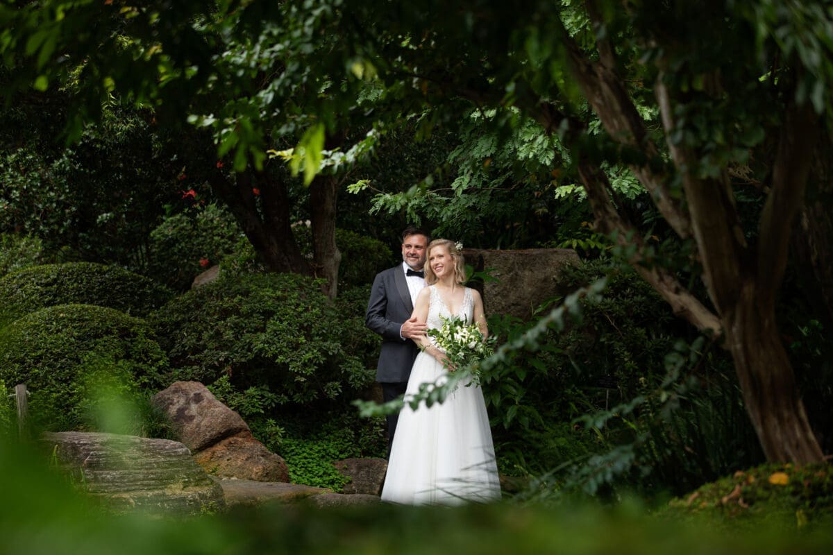 Bride and groom surrounded by beautiful gardens at Mt Coot-tha