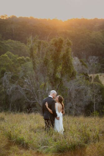 Groom and bride embracing during sunset at Ocean View Estates