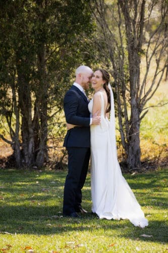 Groom whispering, so only his wife can hear
