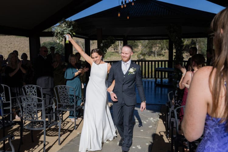 Trish and Nic walking down the aisle as husband and wife