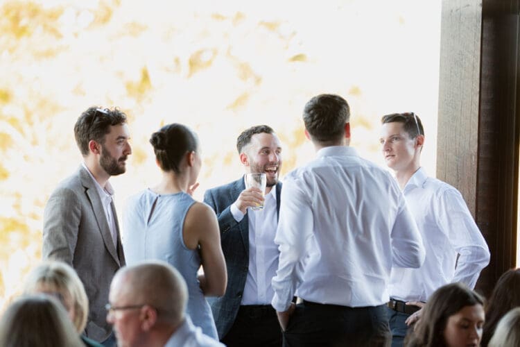 Candid wedding moment with guests laughing