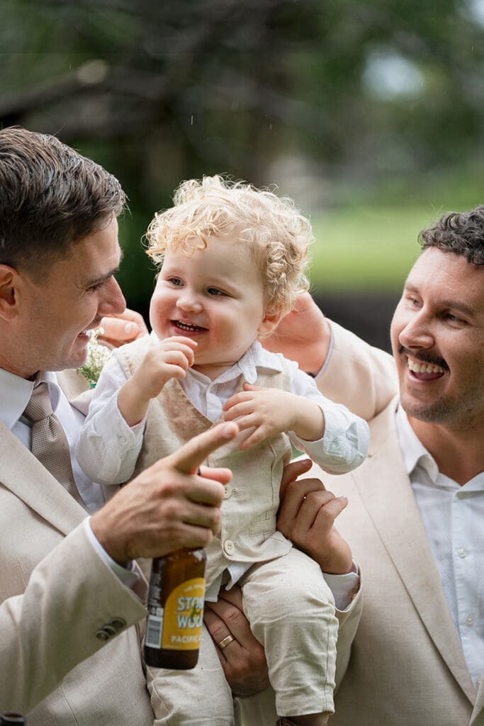Photo of a father making his son laugh at his Gold Coast Wedding