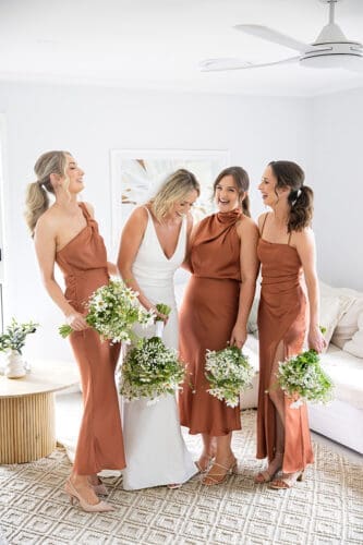 Candid laughter shared between bride and bridesmaids before the ceremony taken by Follett Photography