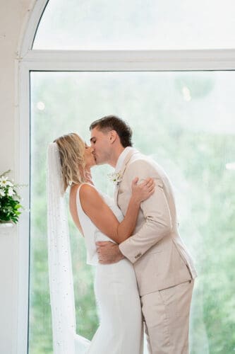 Bride and groom’s first kiss in the chapel at Braeside Gin House Creek Estate